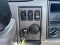 Dashboard control panel of a 2020 Peterbilt 330 featuring cruise control buttons and a key ignition slot