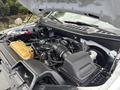 The image shows the engine compartment of a 2020 Ford F-150 with various engine components visible including hoses and a large air intake system
