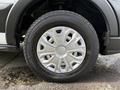 A close-up of a wheel from a 2021 Ford Transit showing a silver rim with a unique design and a black tire with visible tread pattern