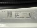 Label on a Freightliner M2 displaying component details including axle specifications and vehicle identification number