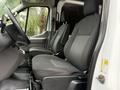 Interior view of a 2020 Ford Transit showing two black fabric front seats with armrests and a steering wheel