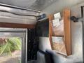 Interior view of a 2011 Workhorse W62 with a wooden file holder displaying several clear documents mounted on the wall