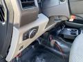 Interior view of a 2018 Ford F-150 showing the dashboard controls and gear shift area with buttons and a cup holder visible