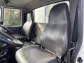 Interior view of a 2012 International DuraStar 4300 showcasing two gray leather seats and a steering wheel with a dashboard visible in front