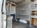 The interior of a 2010 Mercedes-Benz Sprinter showing metal storage compartments and shelving units inside the cargo area
