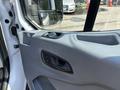 Interior view of a 2019 Ford Transit 350 door panel featuring controls for locks and window with a textured surface and handle