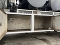 A 2013 International Workstar 7500 with an open storage compartment revealing a dirty interior and visible structural elements of the truck