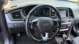 Interior view of a 2018 Hyundai Sonata showing the steering wheel control buttons and dashboard display