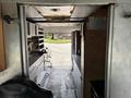 Interior view of a 2011 Workhorse W62 featuring shelves cabinets and a driver's seat visible from the entrance looking into the vehicle's cargo area
