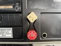 A control panel featuring a golden parking brake lever and a red air supply button labeled "PULL TO EVACUATE TRAILER AIR SUPPLY NOT FOR PARKING"