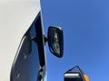 A side mirror of a 2022 Lion Lion6 vehicle reflecting the sky and part of the interior visible through the glass