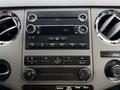 Dashboard of a 2012 Ford F-550 featuring a radio display and climate control buttons