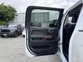 A 2017 Chevrolet Silverado 1500 with the driver's door open showcasing the interior features including the door panel and seat