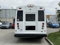 A white 2020 Chevrolet Express van is viewed from the rear with a large rear door and red taillights