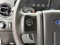 Steering wheel controls of a 2016 Ford F-550 Super Duty featuring buttons for setup info and reset
