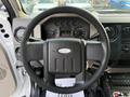 Steering wheel of a 2008 Ford F-450 with various instrument gauges and controls visible on the dashboard