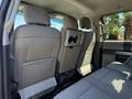 Interior view of the back seat area of a 2019 Ford F-350 SD showing two front seats and a fold-down armrest with cup holders