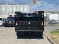 A 2022 Ford F-350 SD is shown from the rear with a black utility bed equipped with lights and compartments