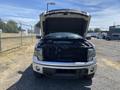 A 2014 Ford F-150 with the hood raised exposing the engine compartment