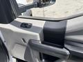 Close-up of the interior door panel of a 2017 Ford F-550 showing the armrest window controls and speaker grille