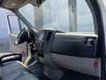 Interior view of a 2016 Mercedes-Benz Sprinter showing the dashboard steering wheel and front seats in a spacious cabin design