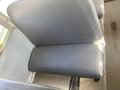 A close-up view of a grey padded bus seat in a Thomas Saf-T-Liner HDX with a clean design and a smooth texture