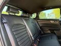Interior view of the back seat of a 2024 Kia Forte5 featuring black leather upholstery and three headrests