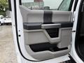 Interior door panel of a 2020 Ford F-550 featuring a two-tone design with storage compartments and a textured grip area