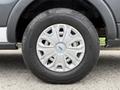 A close-up of a silver alloy wheel with a black tire mounted on a 2017 Ford Transit