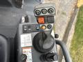 Control joystick of a 2014 Wacker Neuson WL34 featuring buttons labeled A and B along with switches for various functions