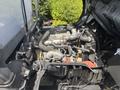 A 2018 Hino 195 engine showing various components including hoses wires and a metal frame with visible parts like the intake manifold and coolant reservoir