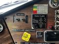 Dashboard of a 1995 Freightliner FL086 showing gauges and controls including engine brake switch, transmission temperature gauge, and fluid level indicators