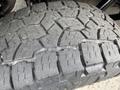 Close-up of a rugged tire tread from a 2021 Ford F-150 showing deep grooves and patterns designed for grip and traction