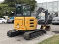 A 2017 John Deere 50G compact excavator with a yellow and black color scheme featuring a rotating cab and a bucket attachment on a rubber track chassis