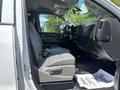Interior of a 2020 Chevrolet Silverado showing gray seating and dashboard طراحی with a focus on the front seats and cabin layout