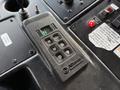 A close-up of a control panel featuring an Allison transmission shifter with buttons for neutral, reverse, drive, and mode