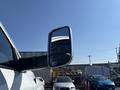 A side mirror of a 2018 RAM 3500 reflecting a clear blue sky