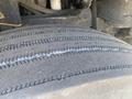 Close-up of a tread from a 1997 Freightliner FL70 tire showing wear patterns with visible grooves and rubber texture