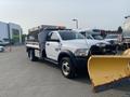 A 2016 RAM 5500 truck with a plow attachment at the front and a flatbed with a salt spreader in the back
