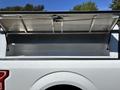 A 2019 Ford F-150 with the truck bed cover opened revealing an empty truck bed space