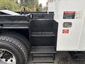 A 2013 Freightliner 114SD with three metal steps leading up to the cabin featuring a textured surface for traction