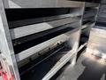 The image shows the interior of a 2023 Mercedes-Benz Sprinter 2500 featuring several metal shelves designed for storage