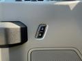 Close-up of the door lock and unlock buttons on the interior panel of a 2017 Ford F-350 SD