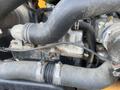 Close-up view of the engine components of a 2013 JCB 510-56 Loadall featuring various pipes and fittings connecting to the engine block