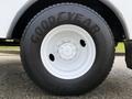 Close-up of a Goodyear tire mounted on a white wheel featuring six lug nuts and a smooth surface design
