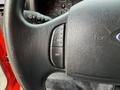 Black steering wheel with buttons labeled ON and OFF visible in the foreground