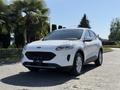 A white 2020 Ford Escape is parked with its front facing the viewer showcasing its sleek design and modern features