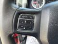 Close-up of a steering wheel control panel featuring buttons for voice recognition navigation and phone functions