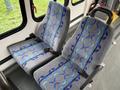 Two gray and blue patterned seats from a 2009 Ford Econoline van with seatbelts attached