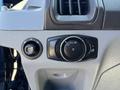 Control panel of a 2016 Ford Transit 150 featuring headlight and dashboard light adjustments with a dial and switch